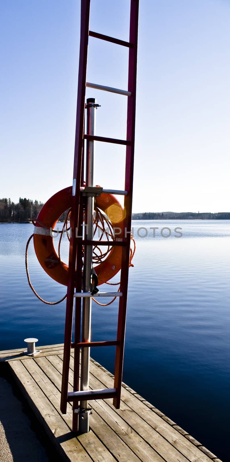 lifeboy in front of a blue sea