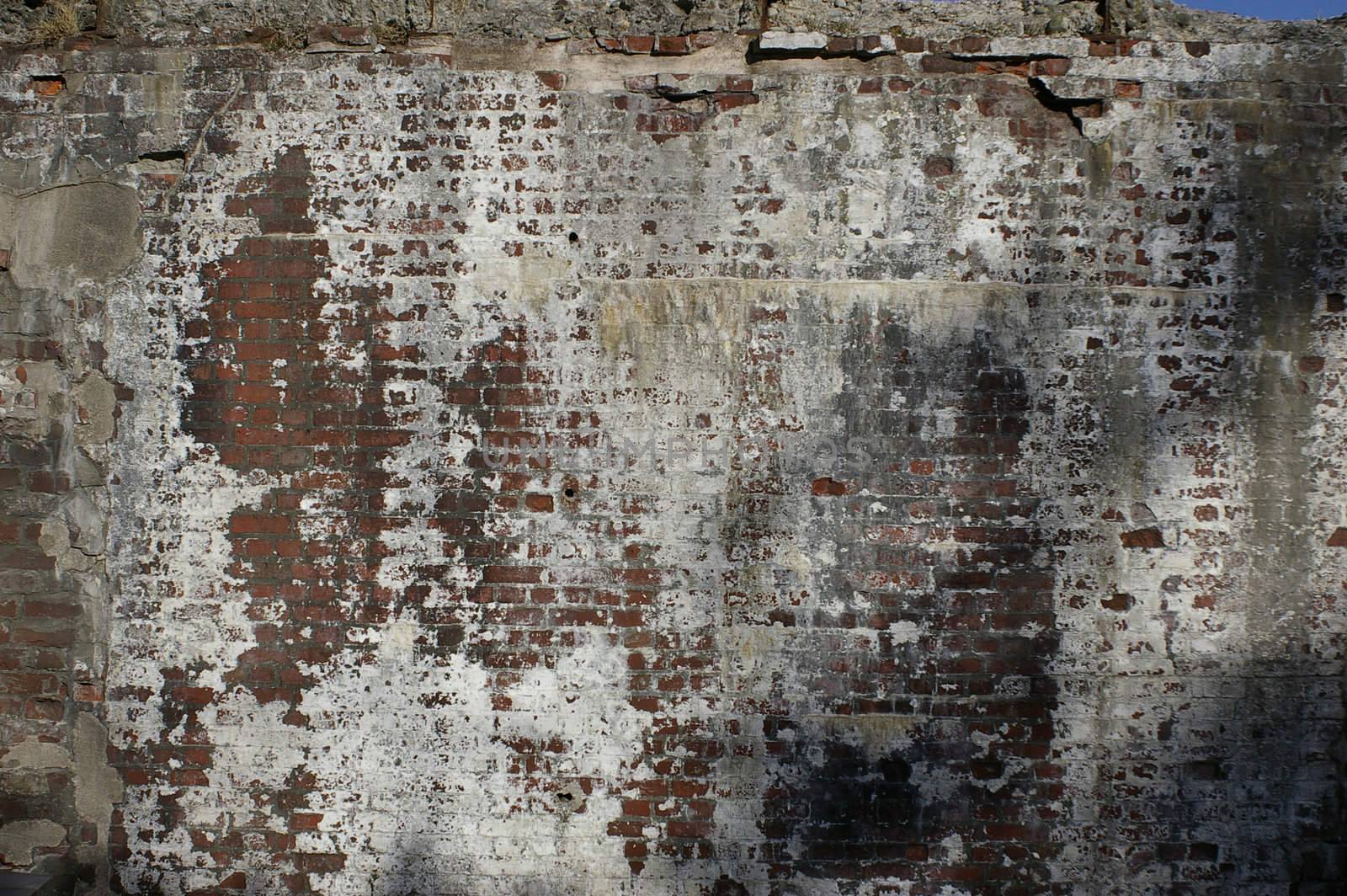 An old brick wall background that has been well weathered from many years of neglect.