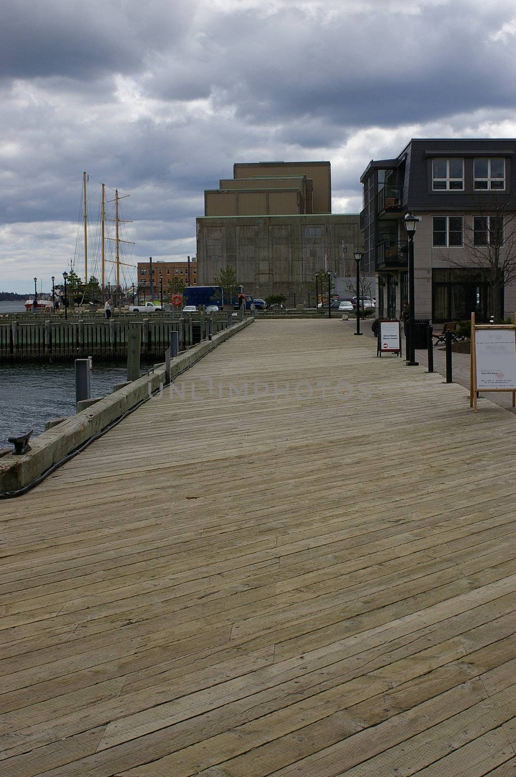 A view down the boardwalk with the water on one side and buildings on the other