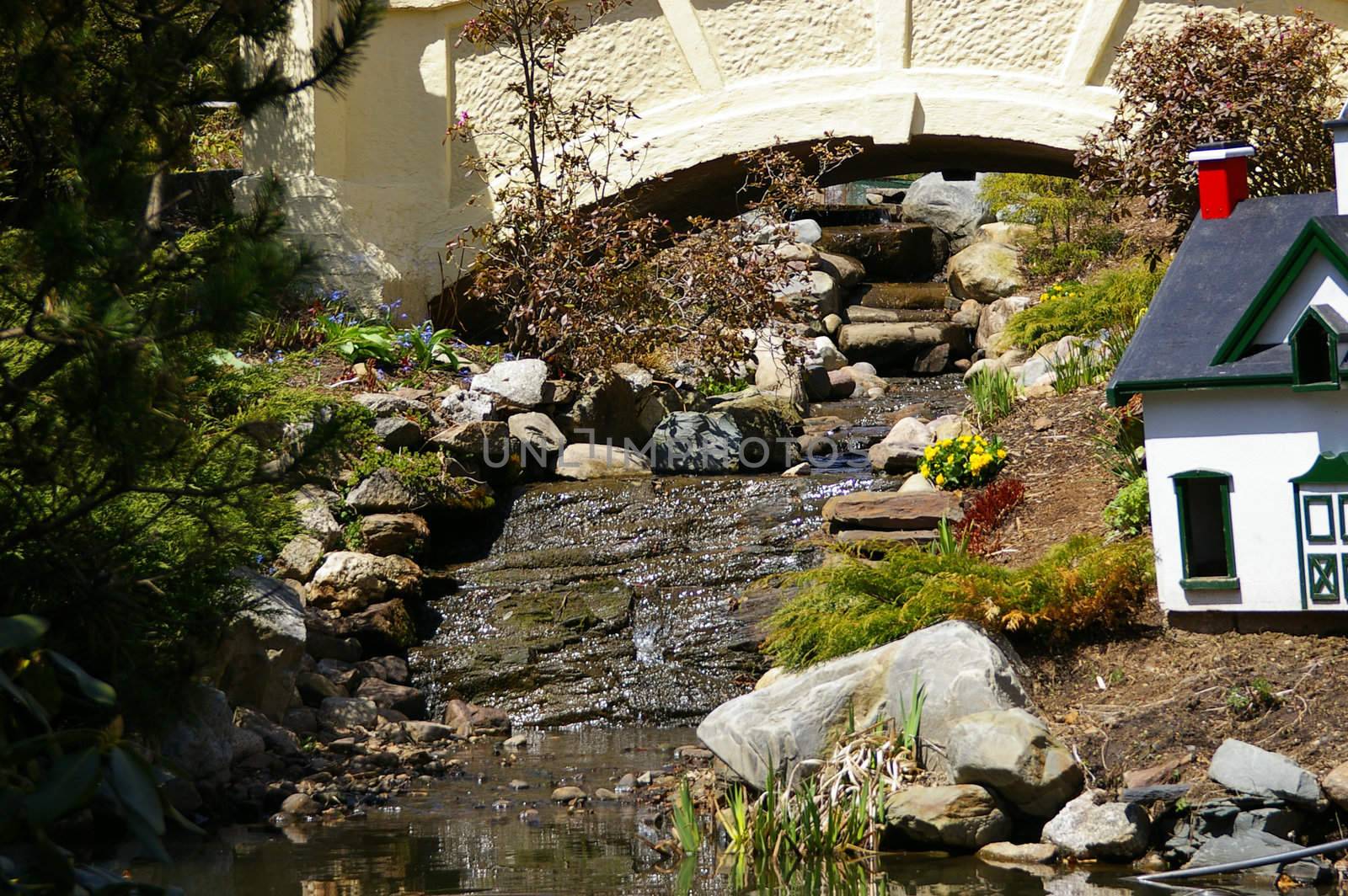 A calm stream running through a park on a spring day.