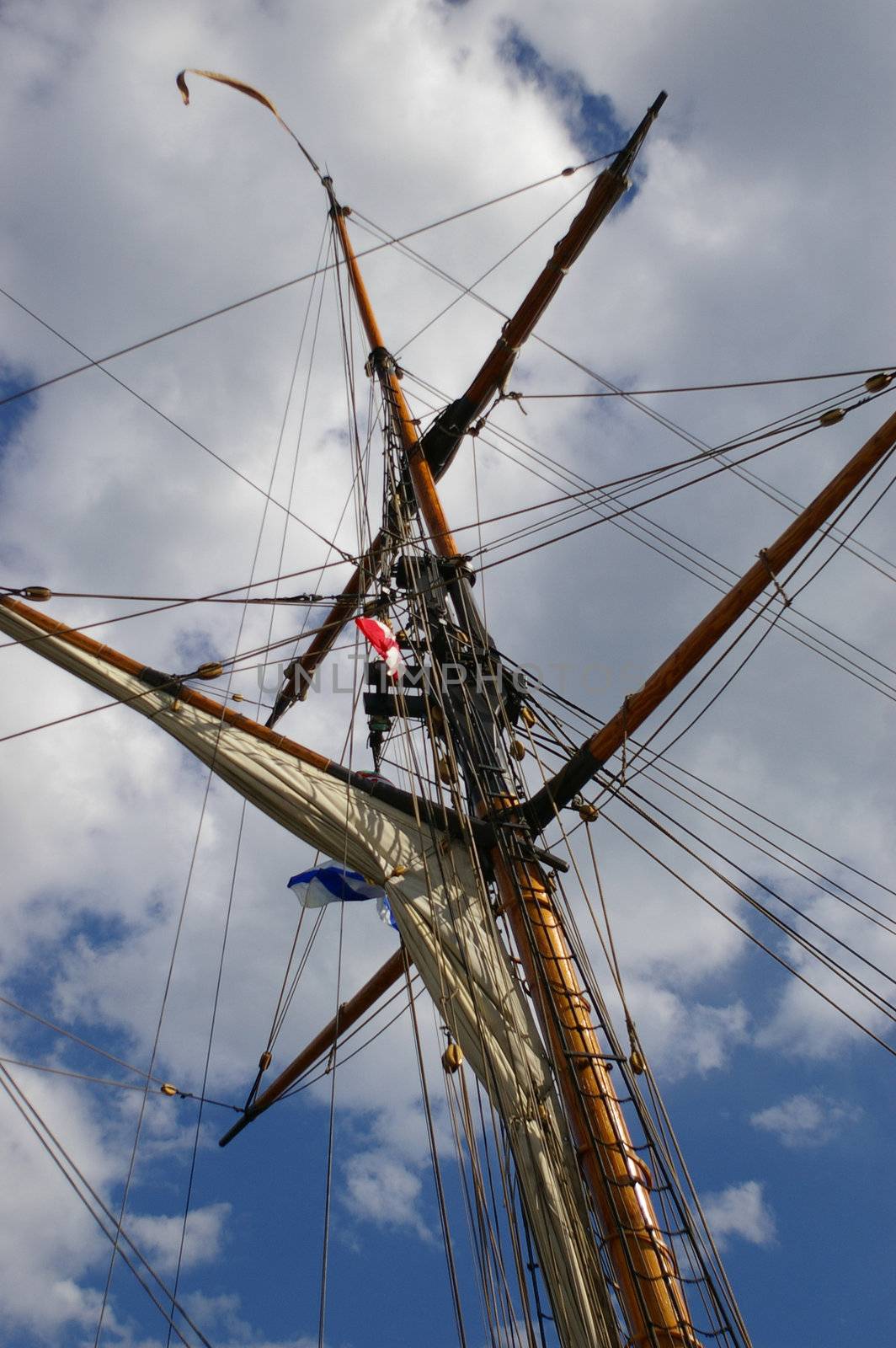 A ships mast reaching high into the sky.