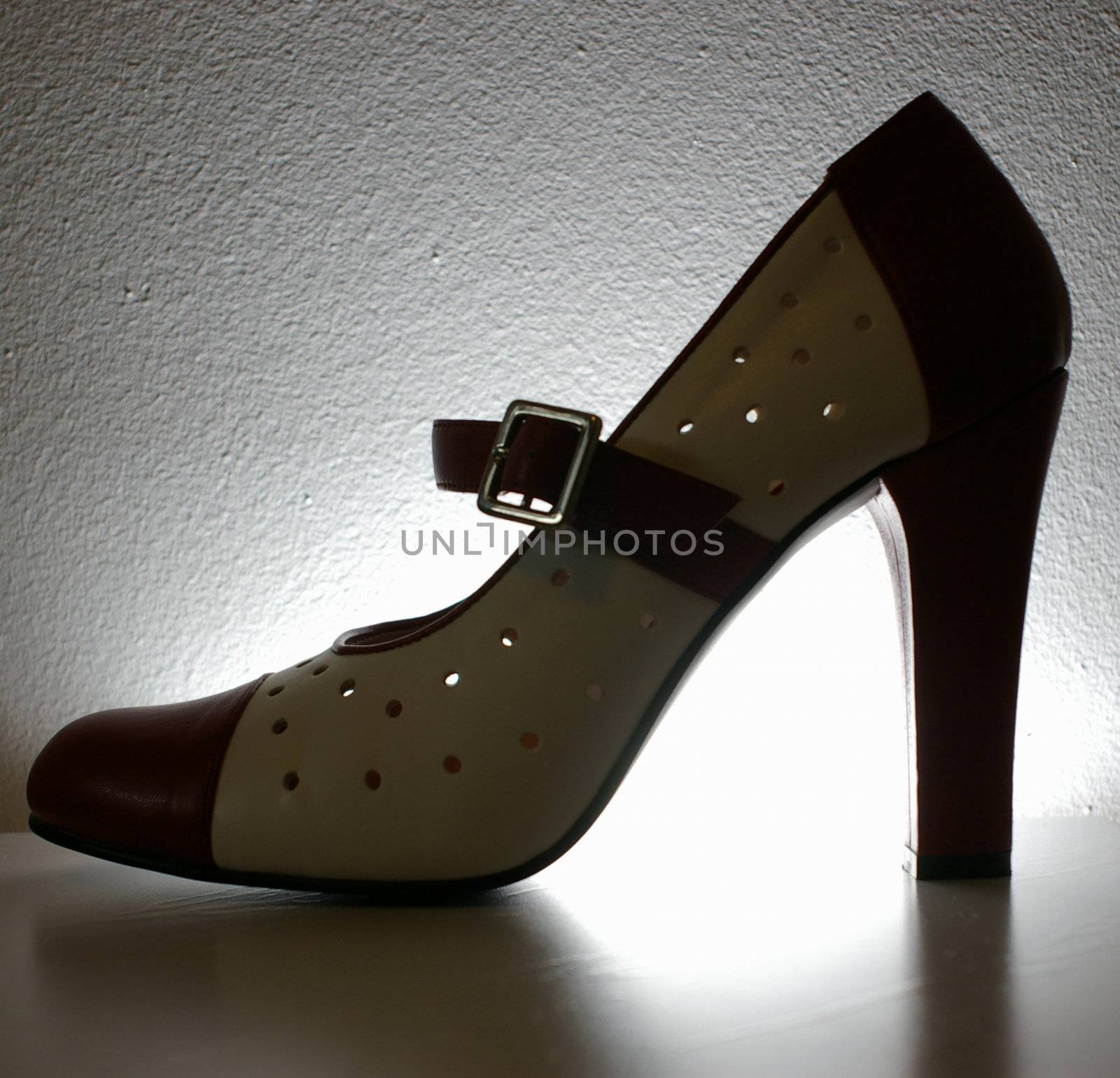 A backlite red and white ladies high heel shoe.