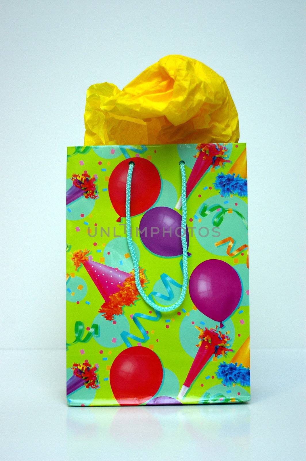 A gift bag for celebrations, Christmas or birthday gifts with tissue paper sticking out.
