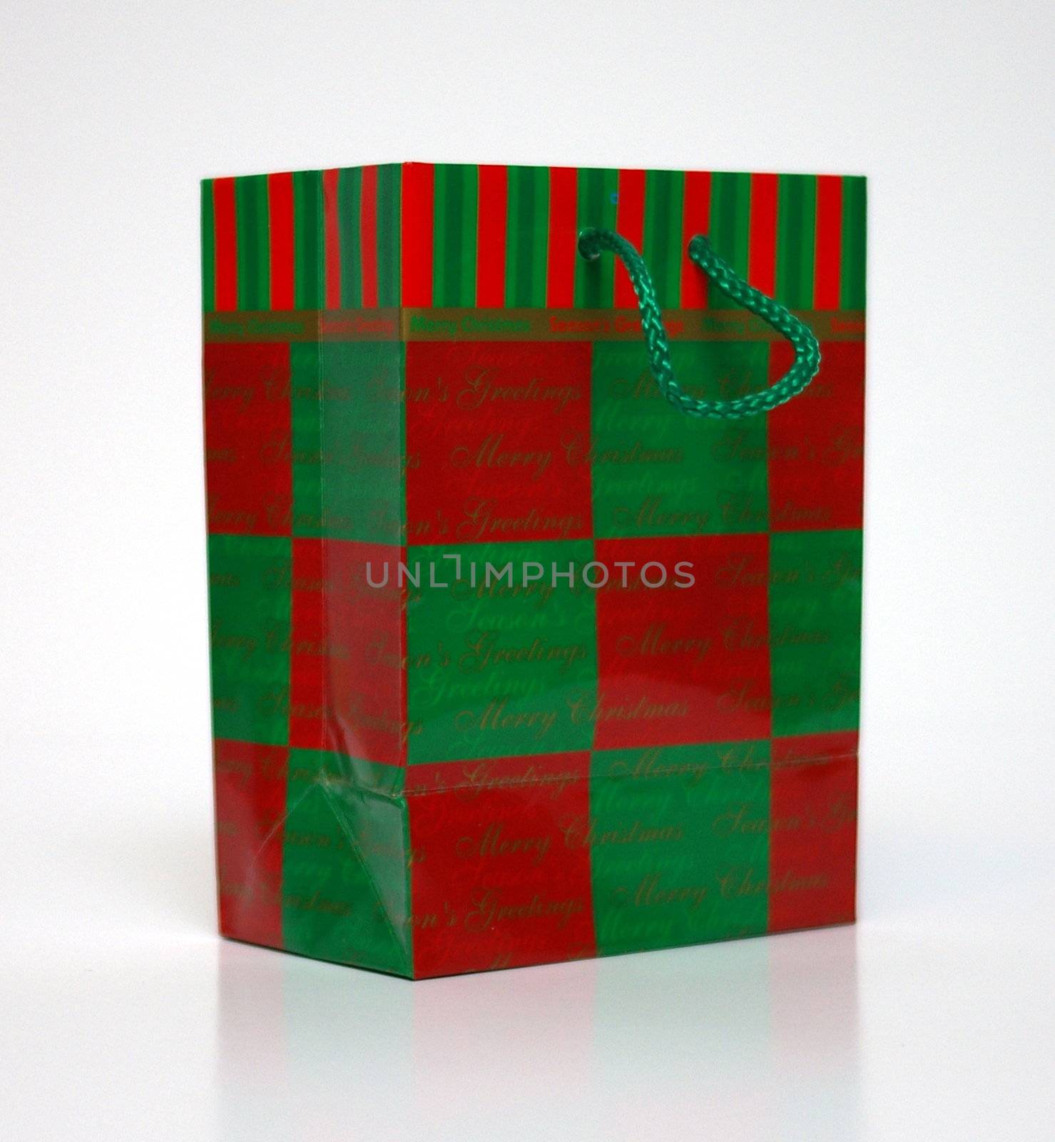 A red and green gift bag on a white background