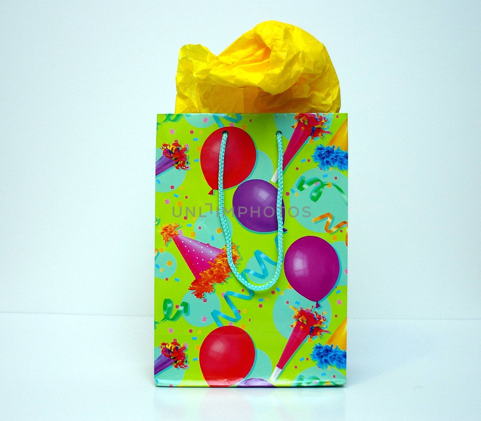 A gift bag for celebrations, Christmas or birthday gifts with tissue paper sticking out.