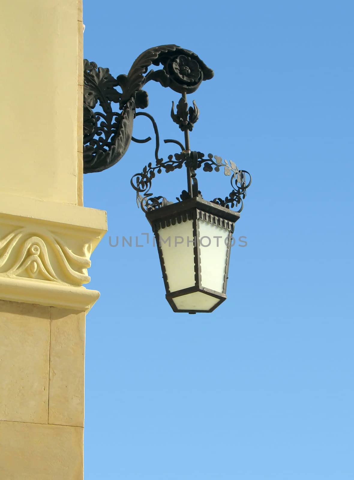 old-fashioned wall lamp with blue sky as background