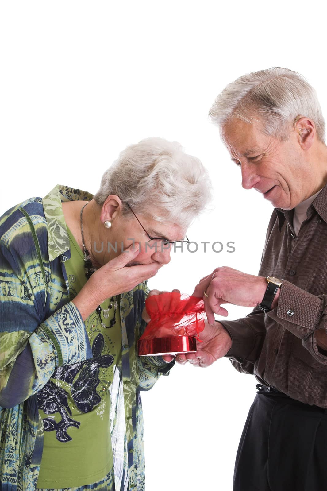 Elderly man giving his wife a box of valentine chocolates
