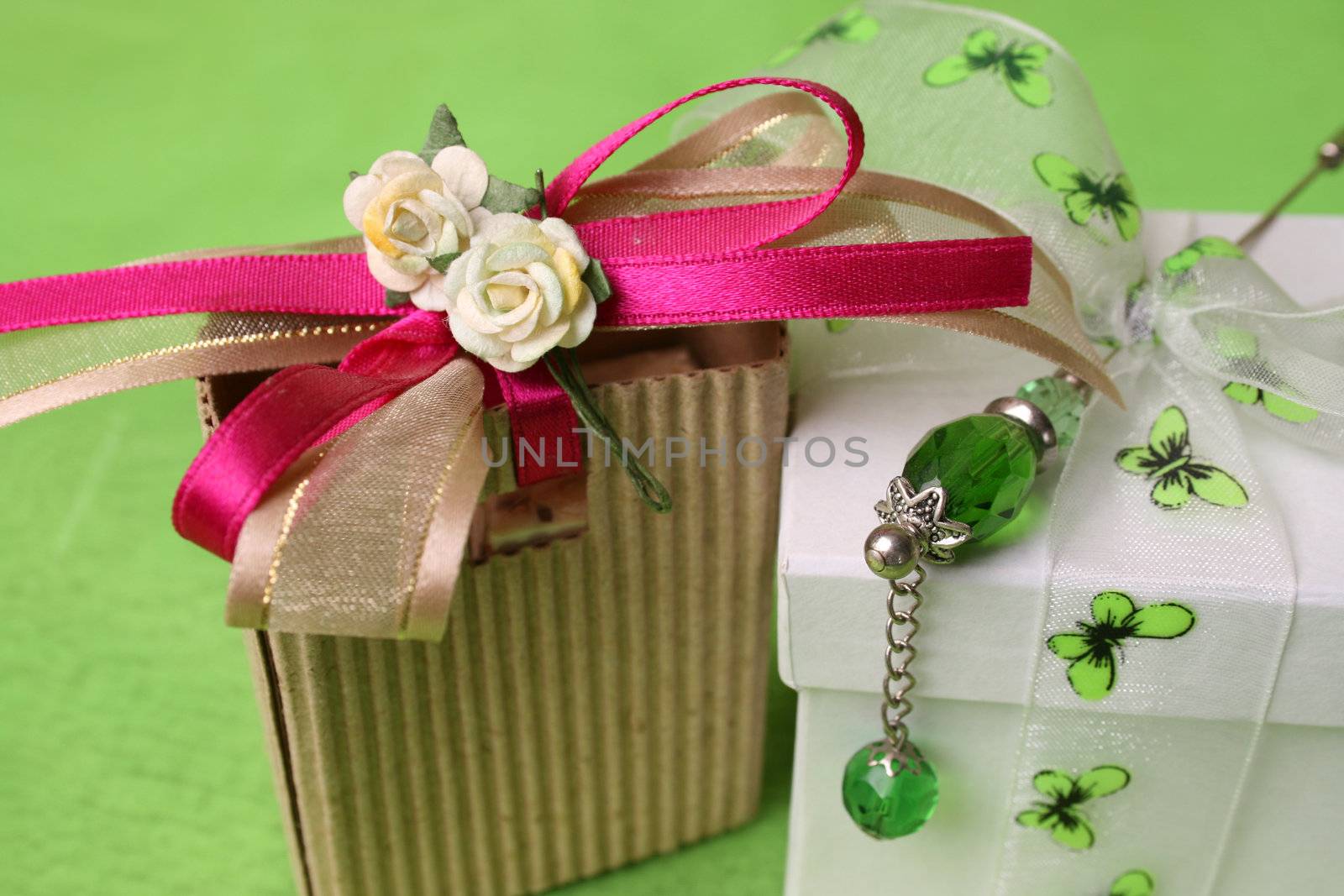 White gift box and small brown gift bag with ribbons