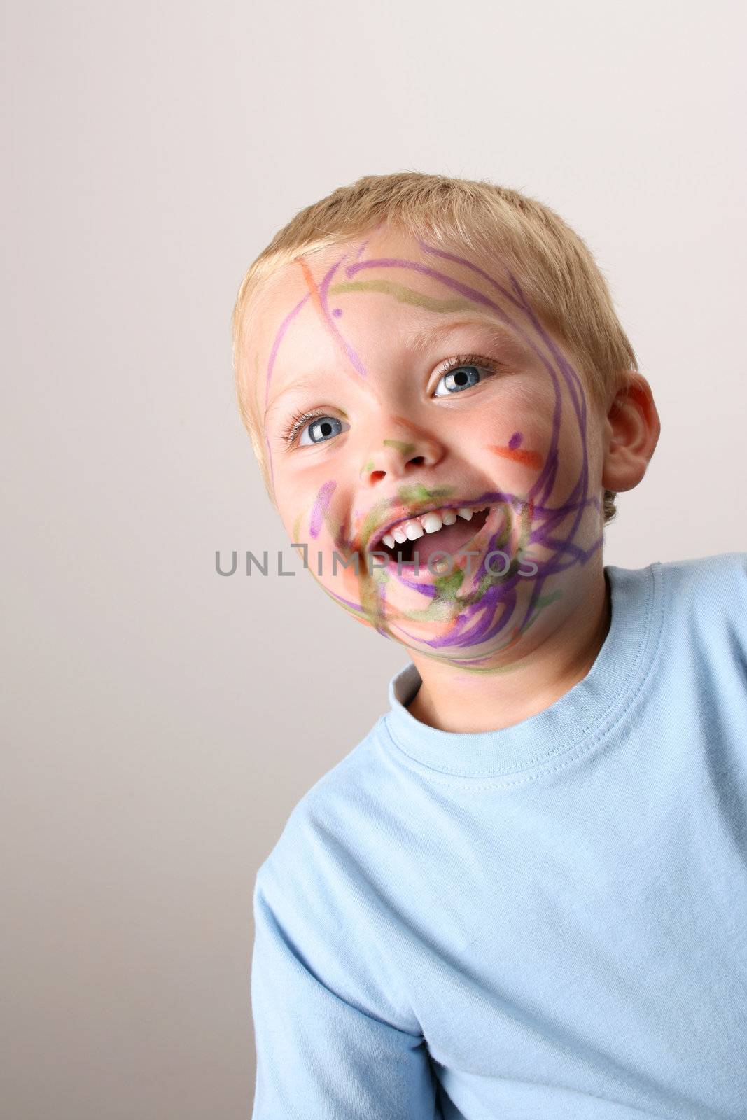 Laughing Toddler playing with colored pens making a mess