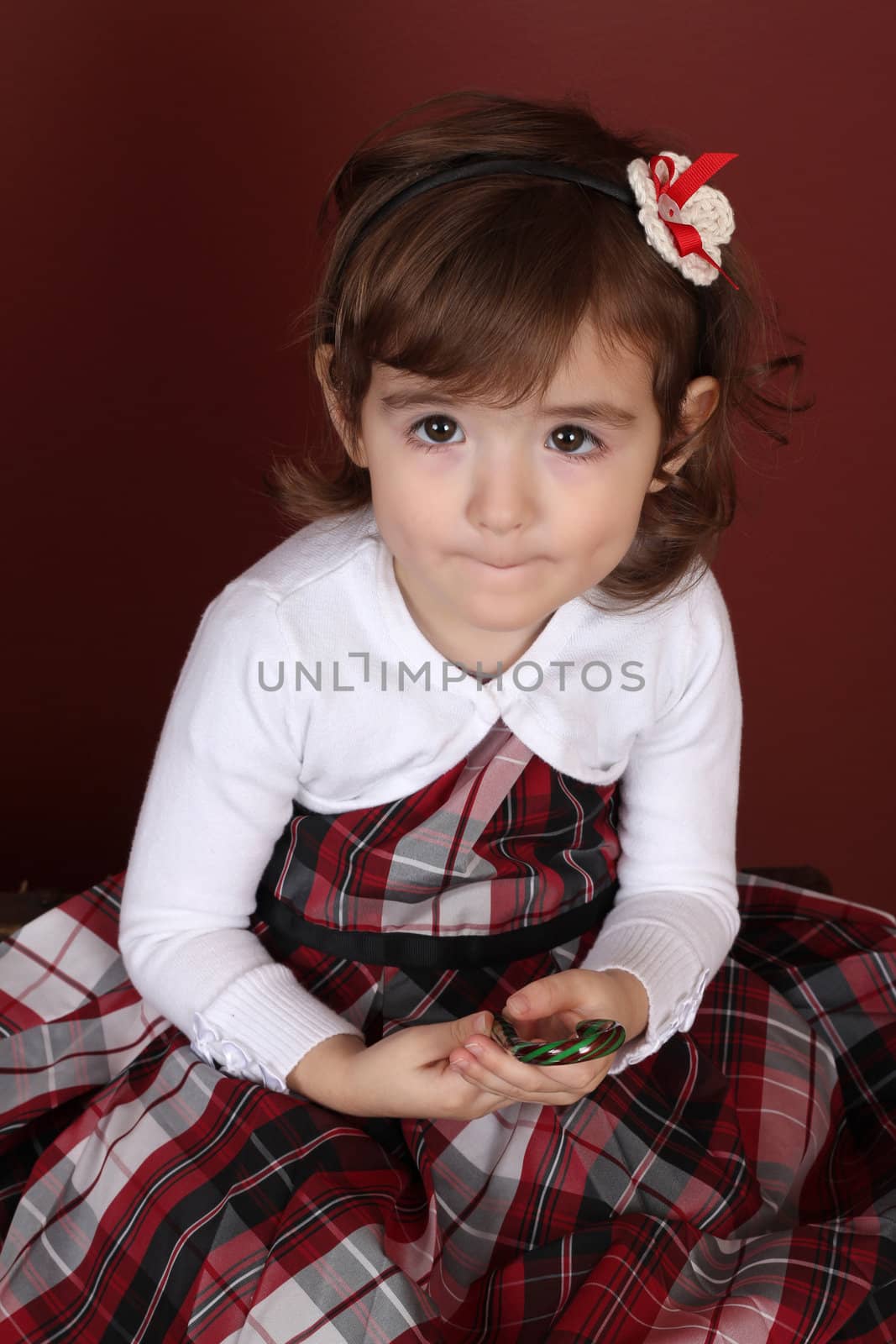 Cute little brunette toddler with serious expression