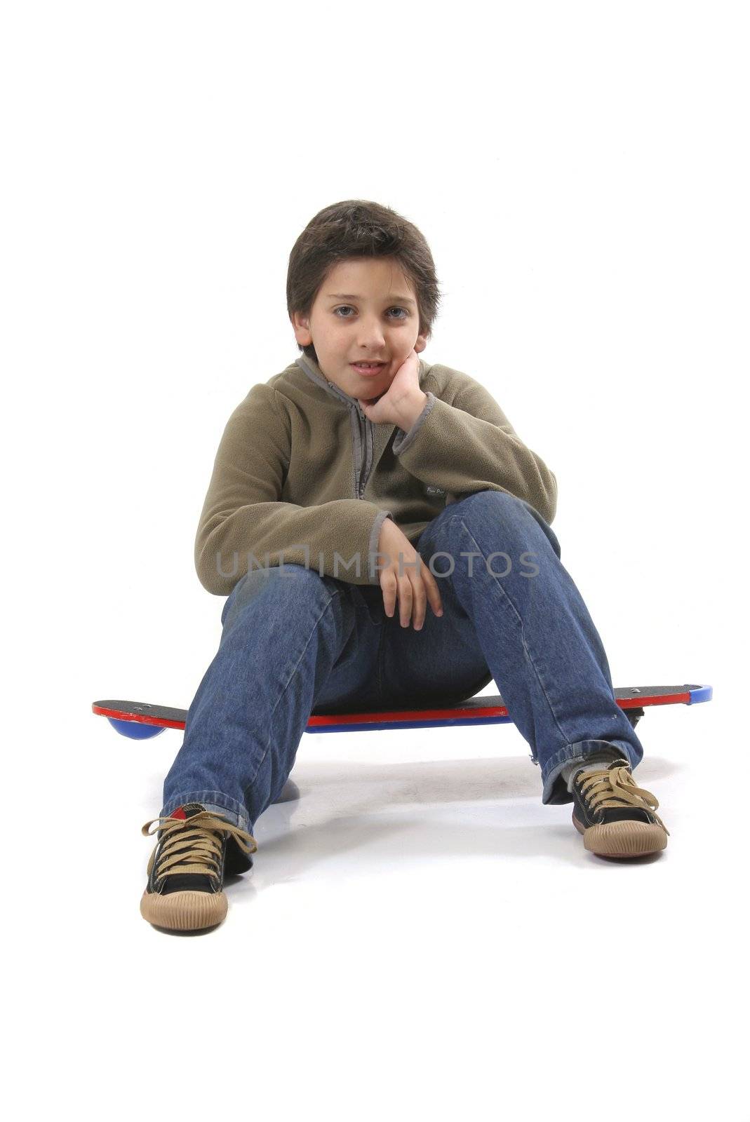 Cool boy sitting on a skate. Full body, white background. More pictures of this model at my gallery