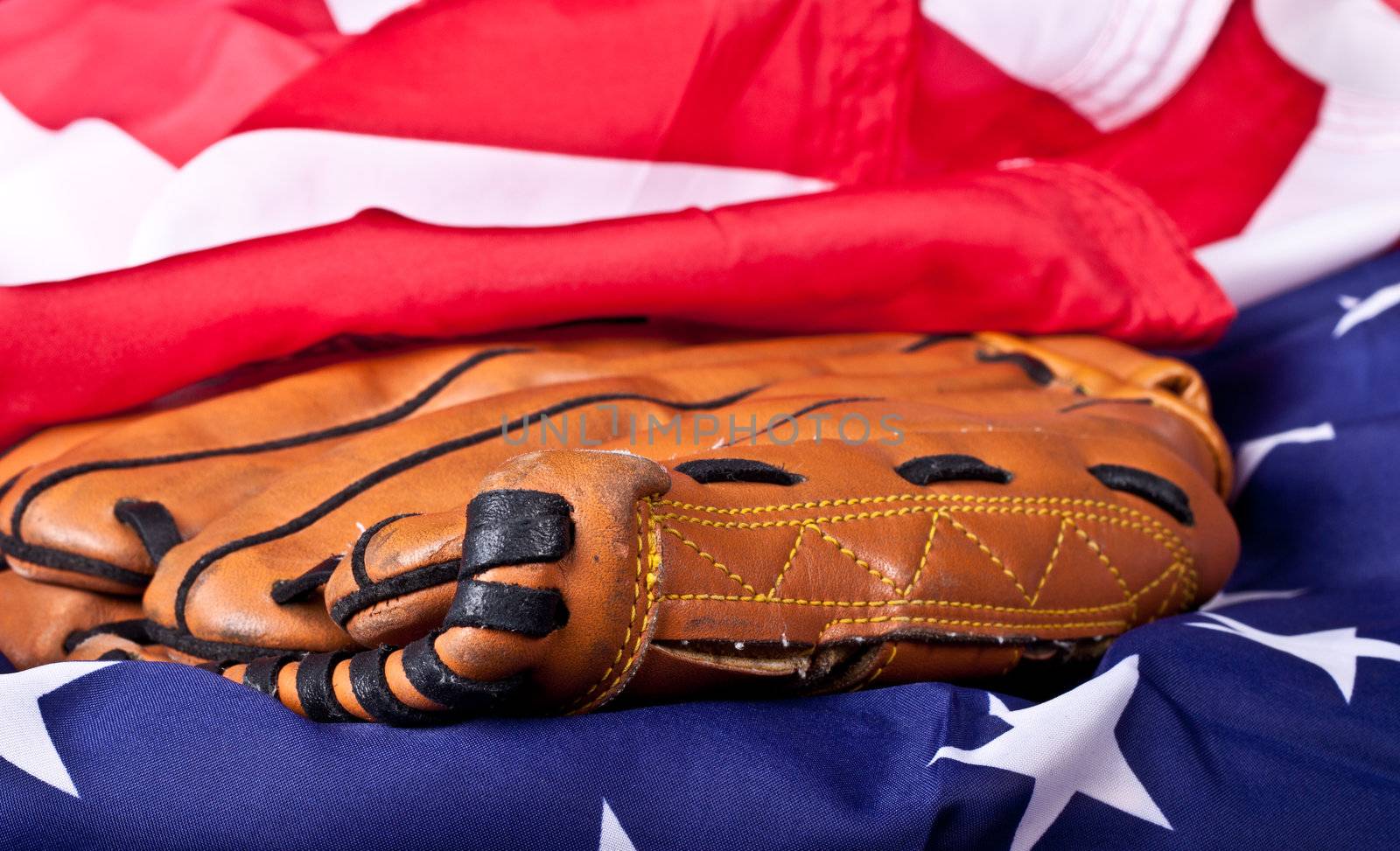 An abstract photograph of a baseball glove and an American flag.