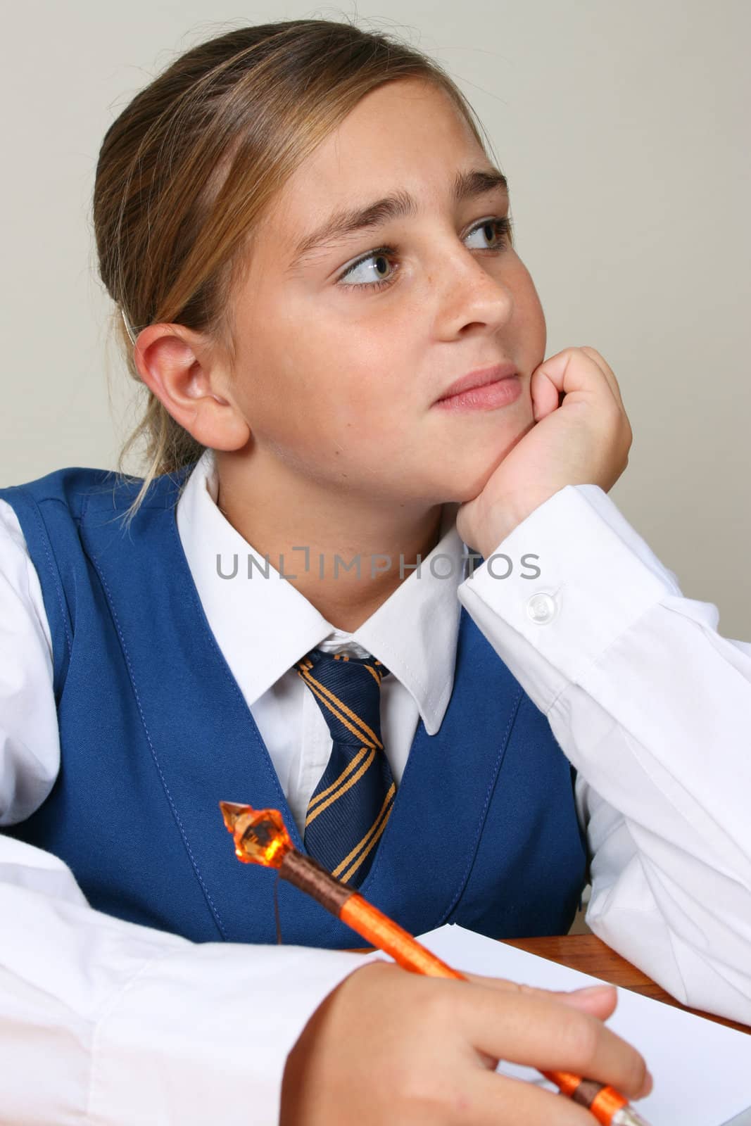 Teenage School girl busy with her homework, wearing uniform