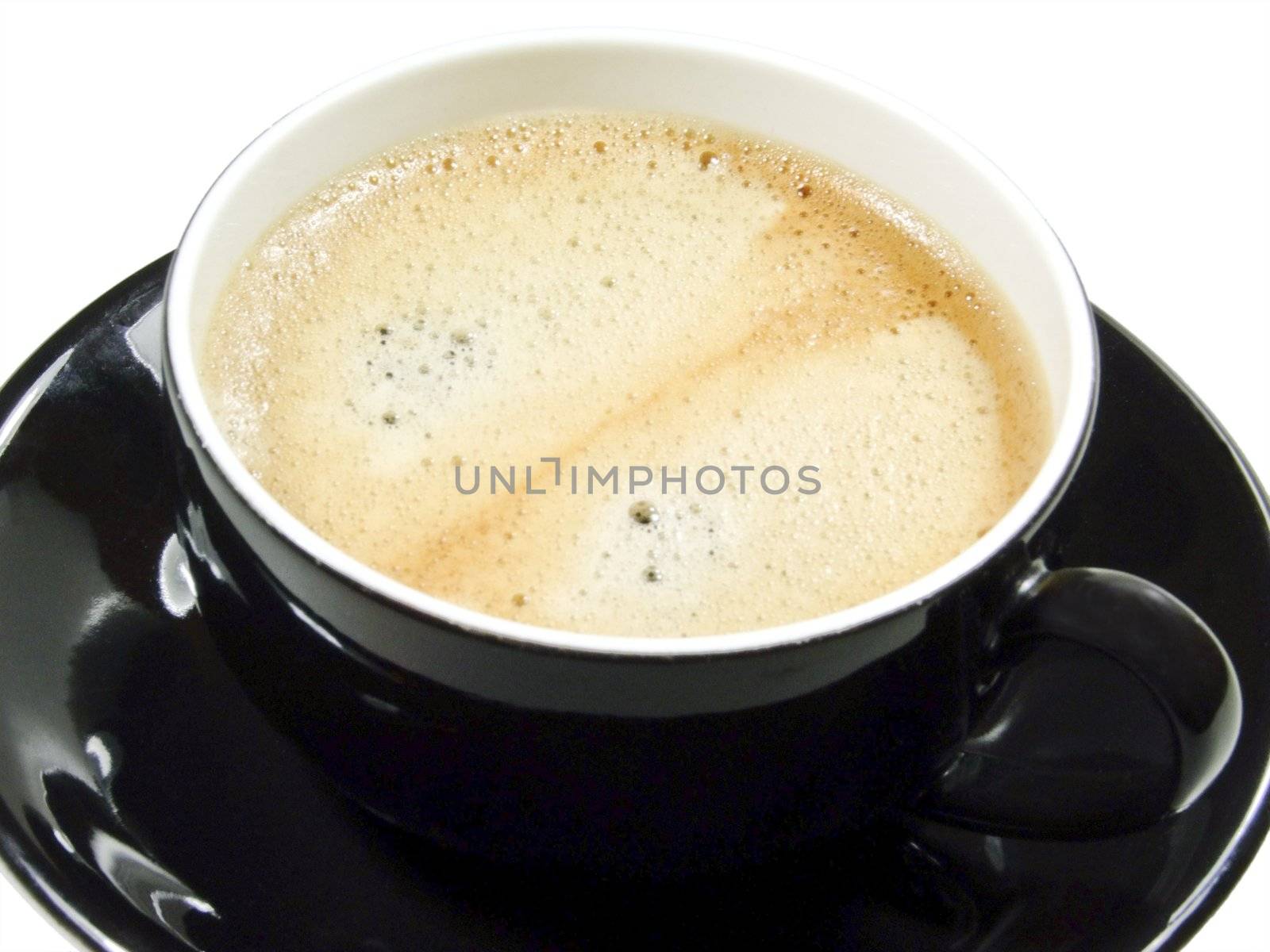Coffee with crema in a black cup - isolated over white background