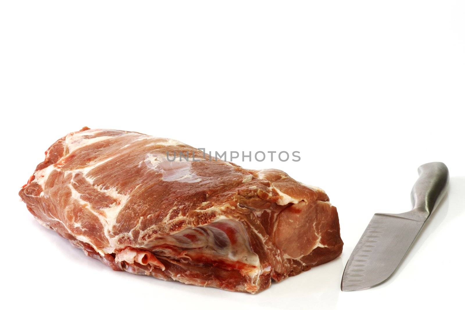 Raw pork roast with knife - isolated over white background