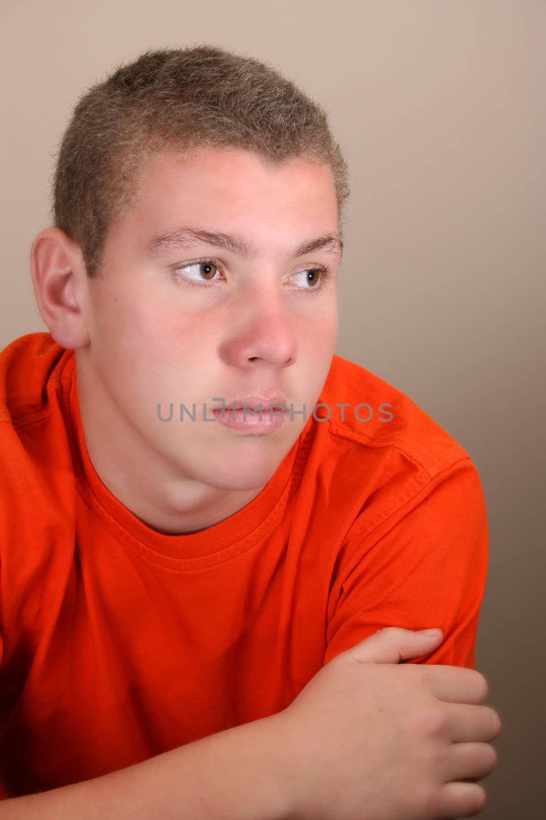 Teenage male in casual attire looking into the distance