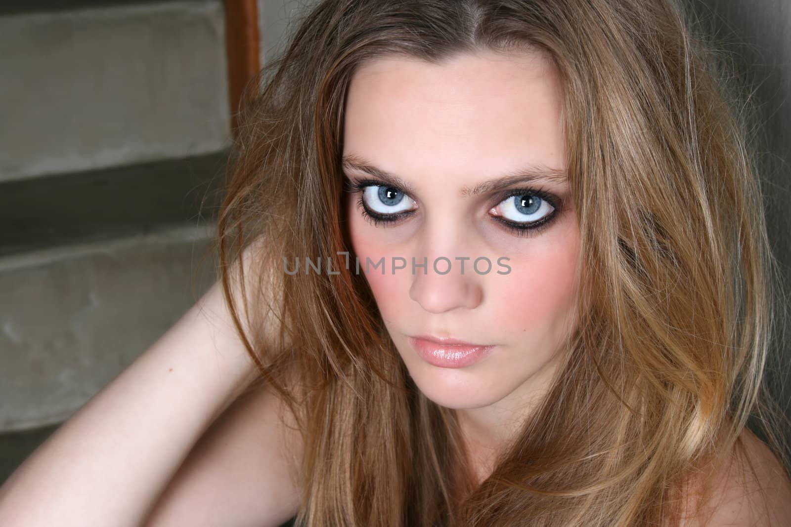Beautiful female model with blue eyes and dark make up