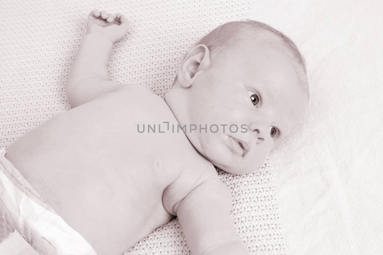 Month old baby boy on a light blanket. Sepia Tone