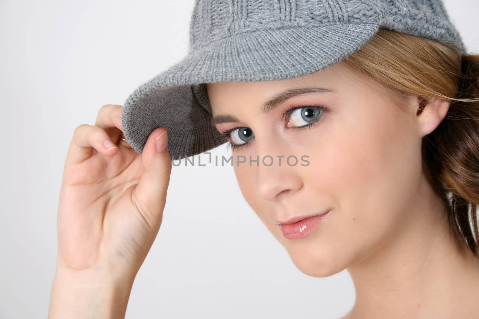 Beautiful young female model wearing a grey hat