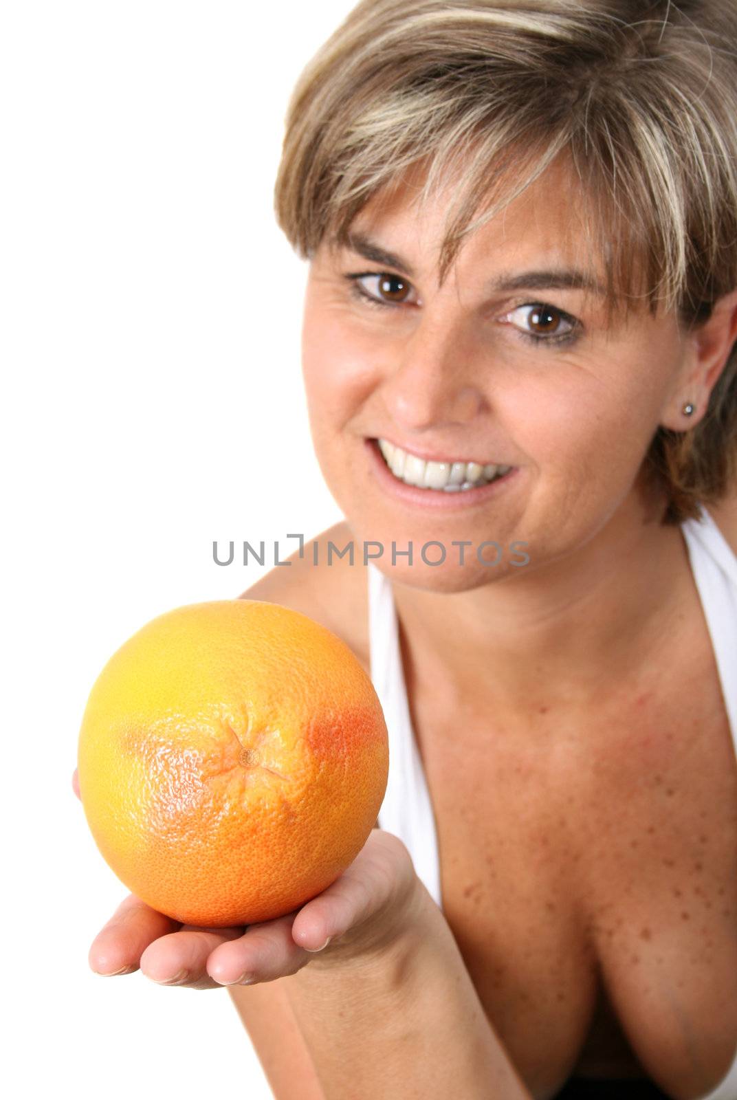 Beautiful mature female holding fruit.  FOCUS ON ORANGE