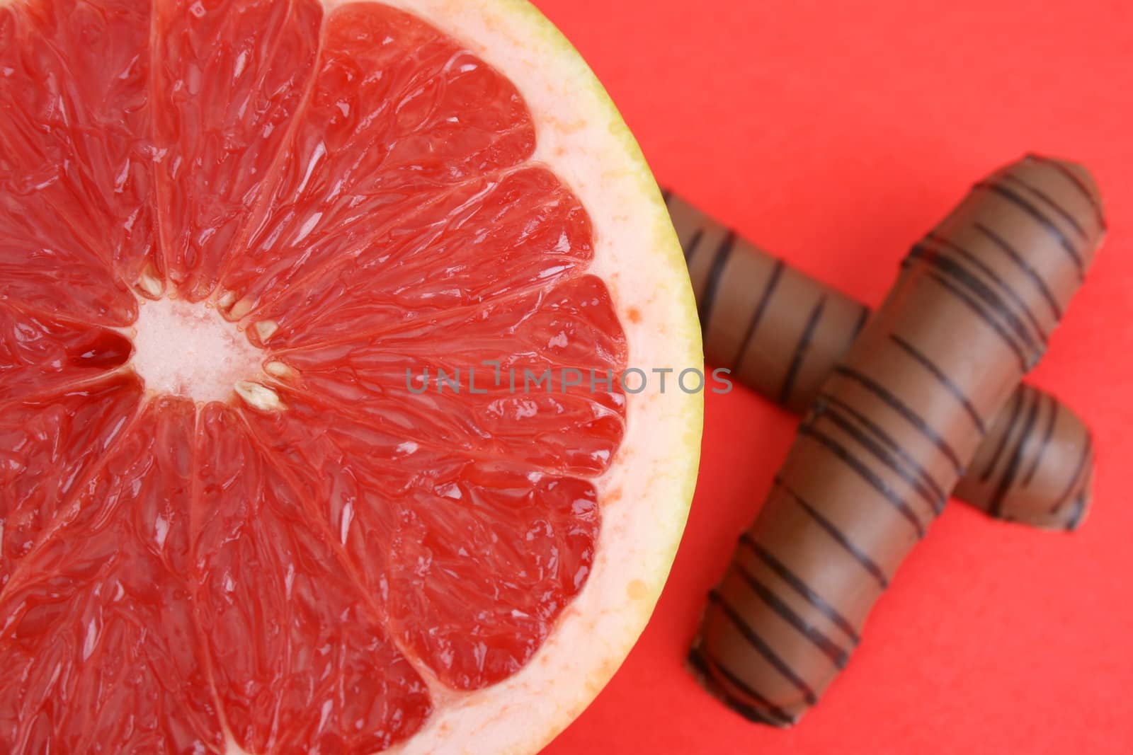 Half Sliced Pomelo and chocolate on a bright background