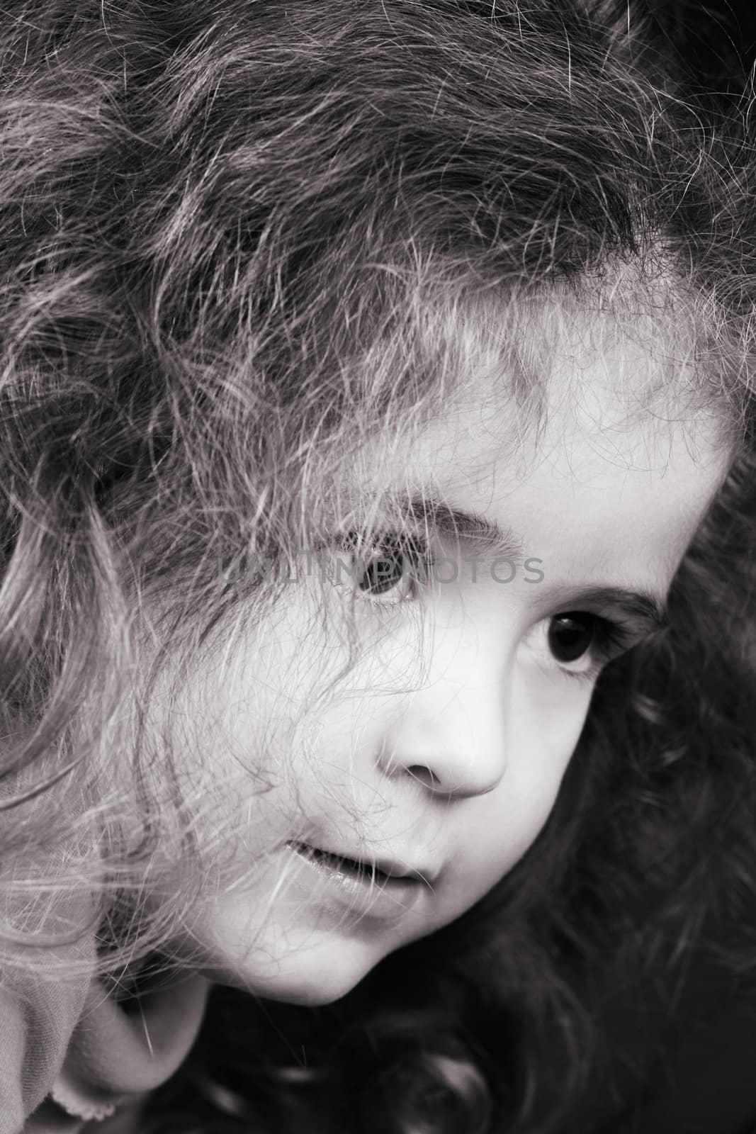 Beautiful young girl with curly hair and cute features
