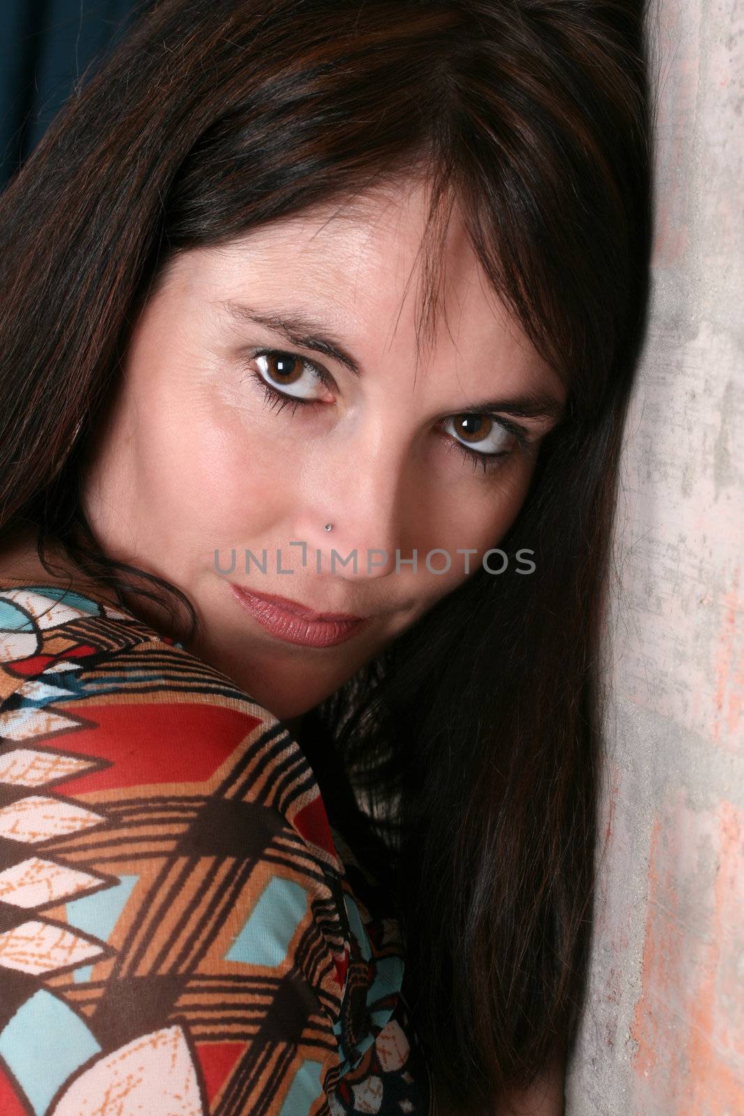 Beautiful brunette woman against a brick wall background