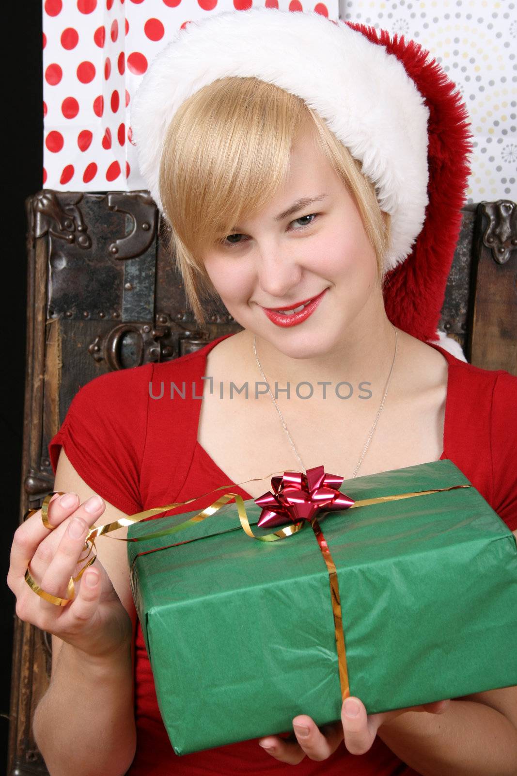Beautiful blond female holding a christmas present