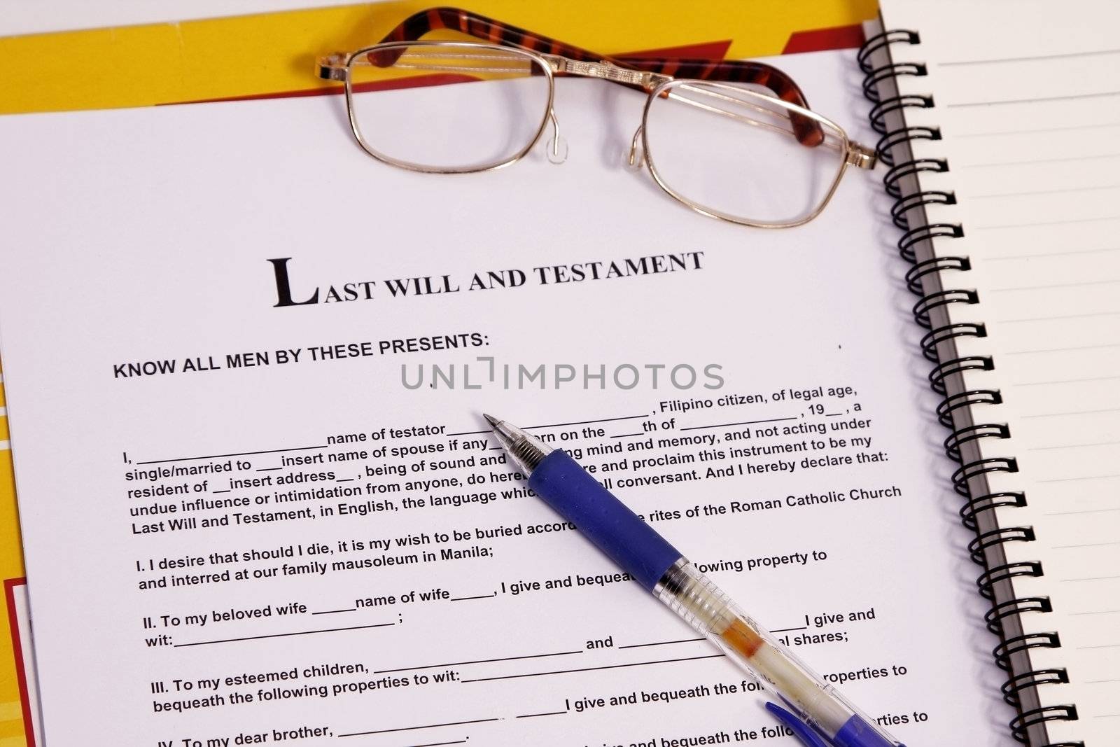 last will and testament form with notebook and pen.
