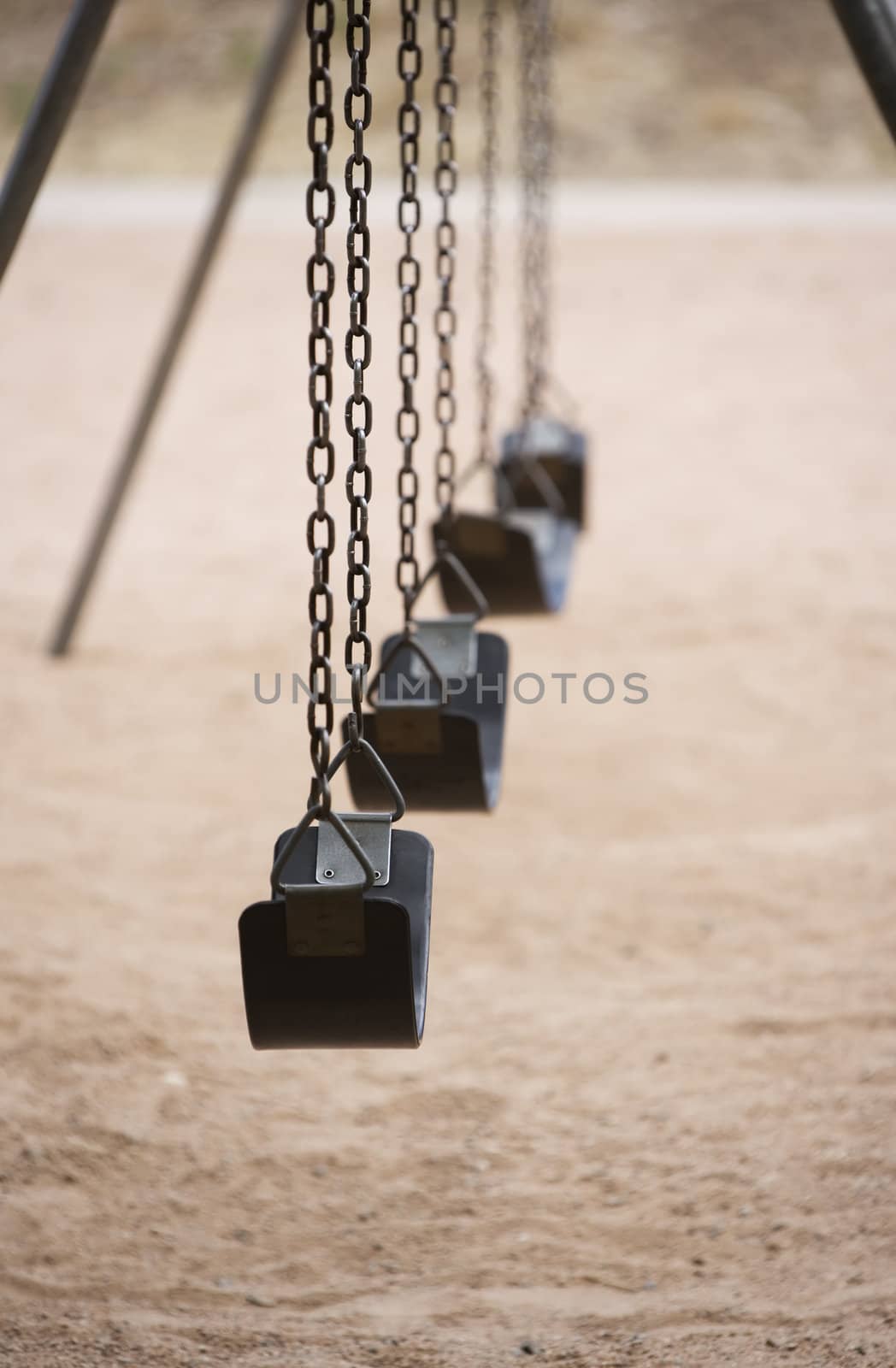 Old style playground swings with chains and rubber seats