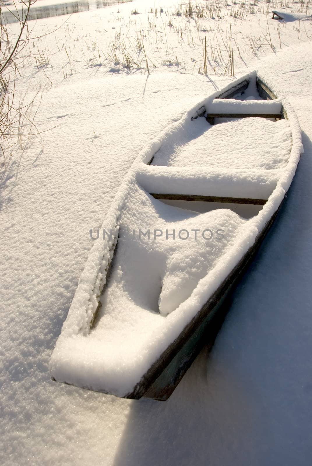 winter boat with snow near river