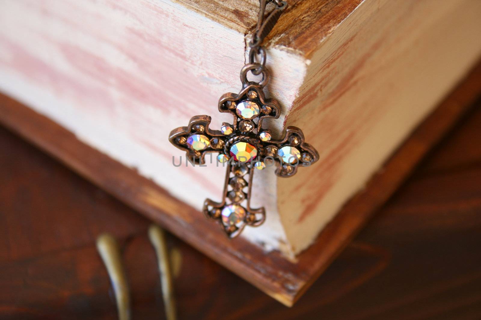 Close up of cross in the form of Jewellery on a wooden Jewellery box