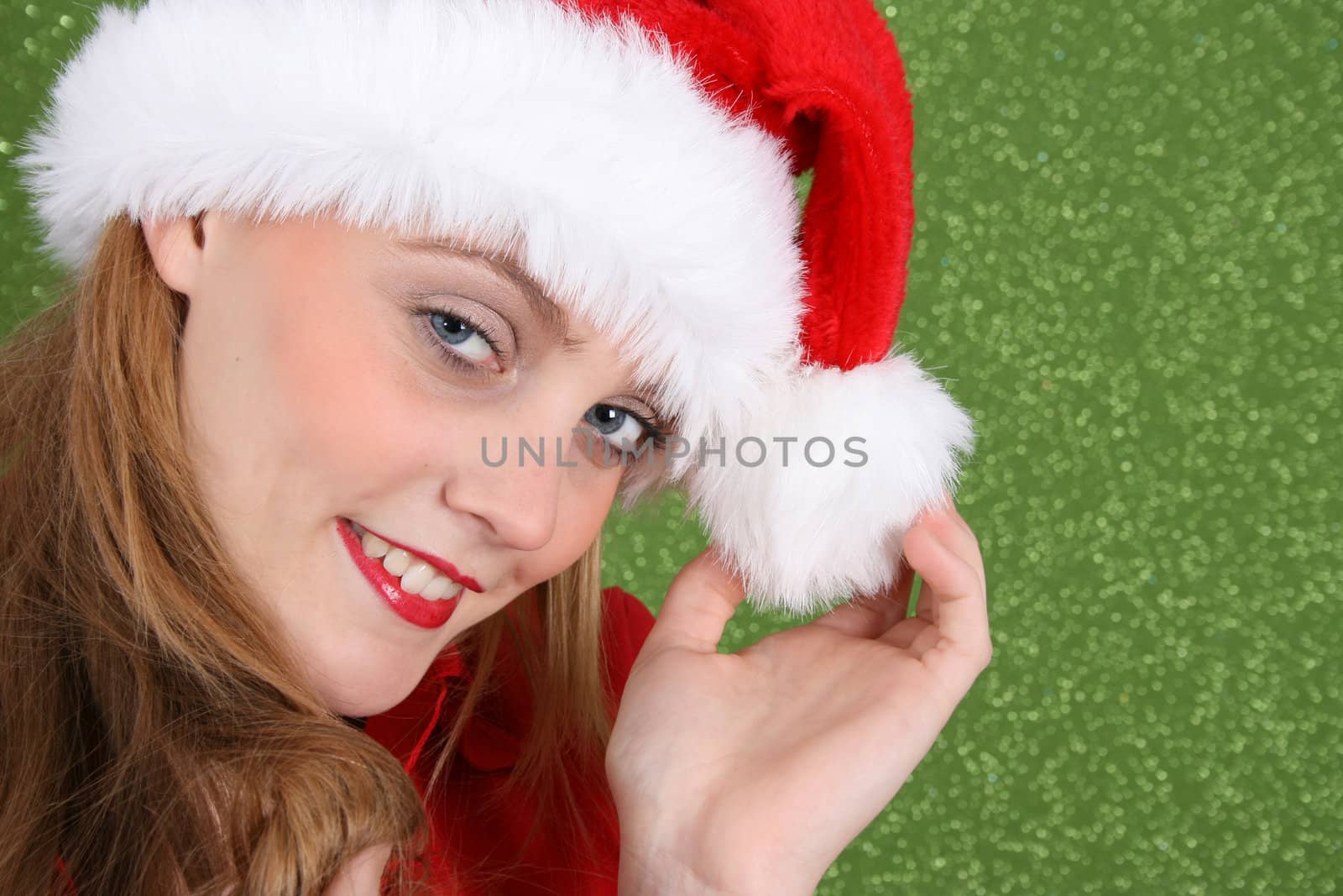 Female Model with red lips wearing a christmas hat