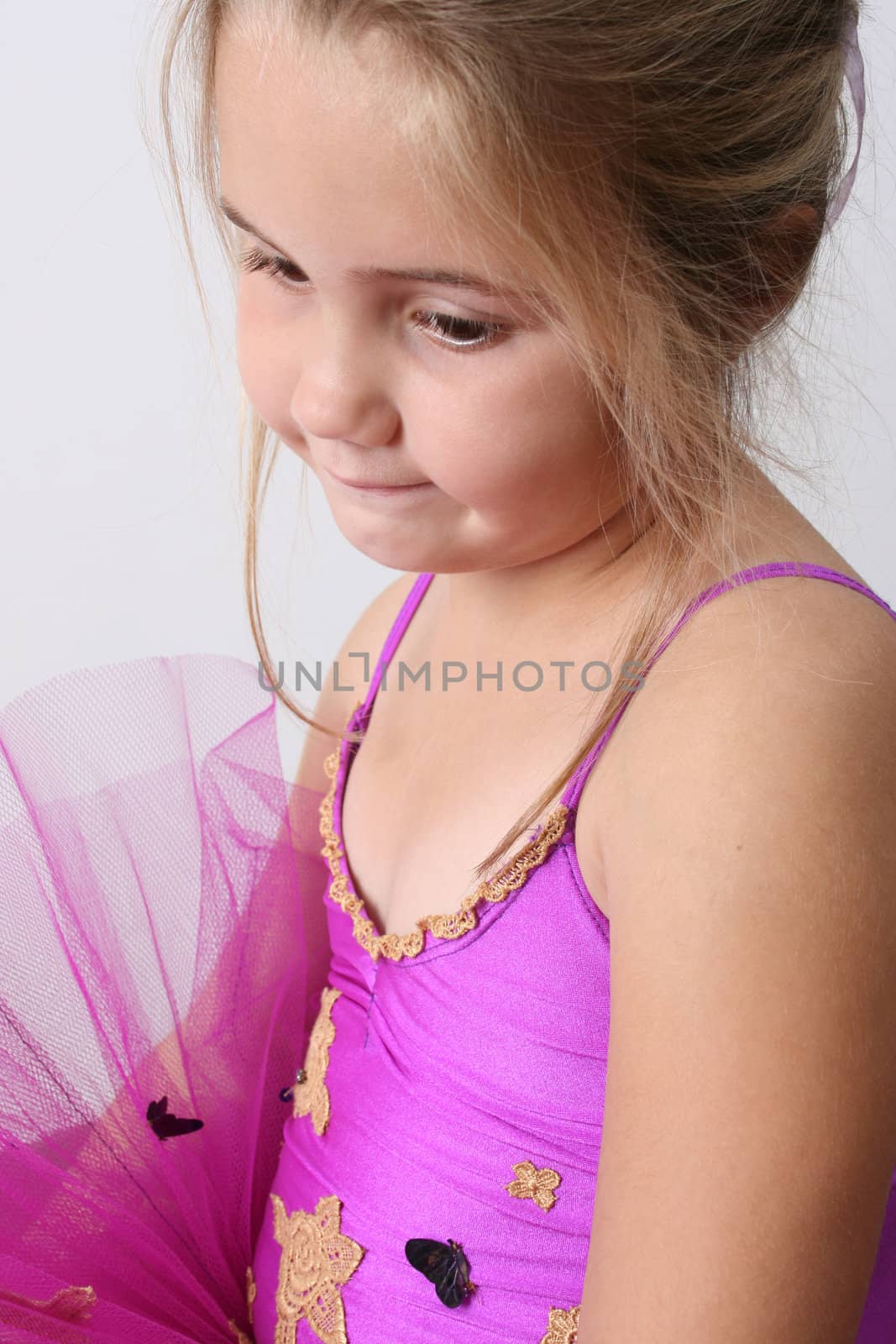 Young girl wearing a tutu dreaming of becoming a ballet dancer 
