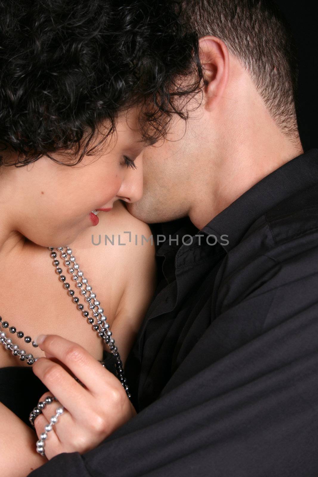 Loving couple in an embrace, female looking down
