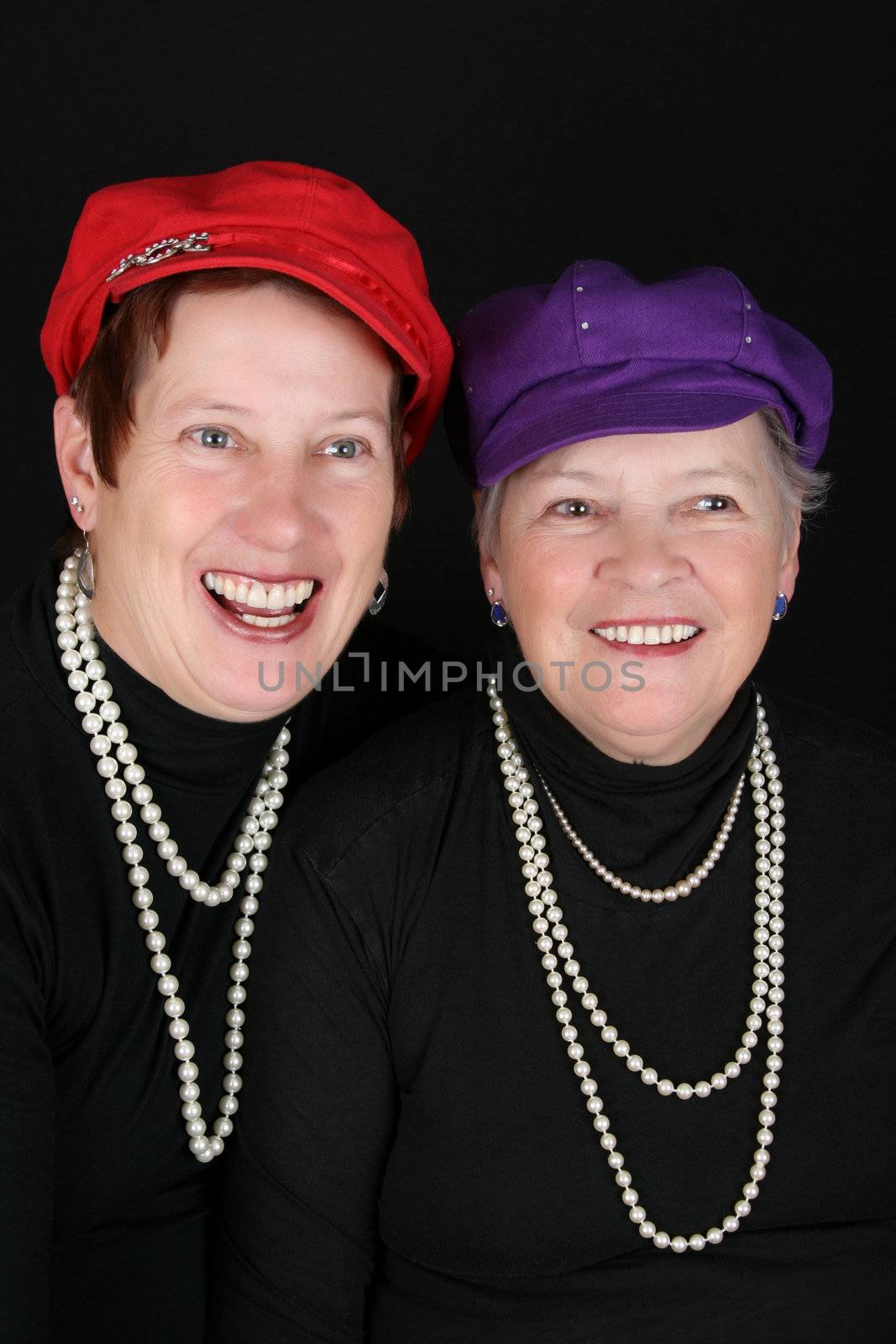 Adult mother and daughter wearing red and purple hats 