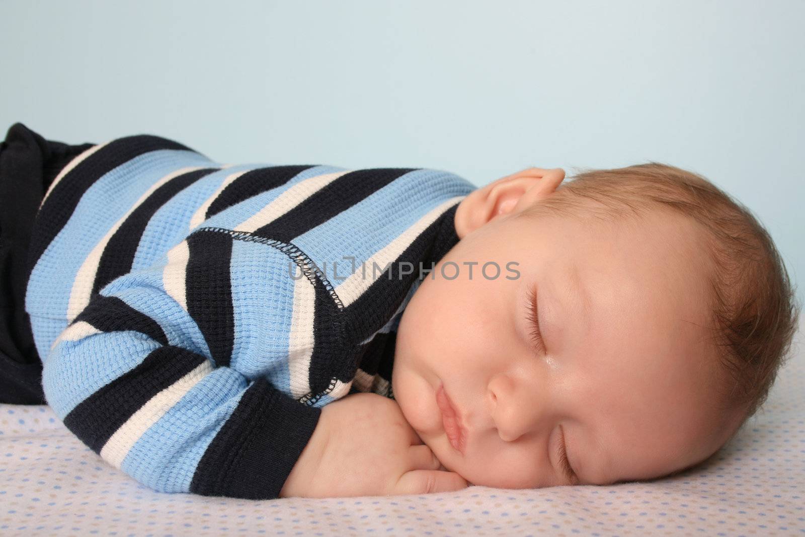 Two month old baby boy on a dotted blanket