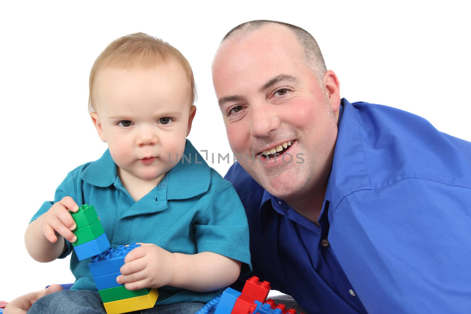 Father and son building with colorful blocks 