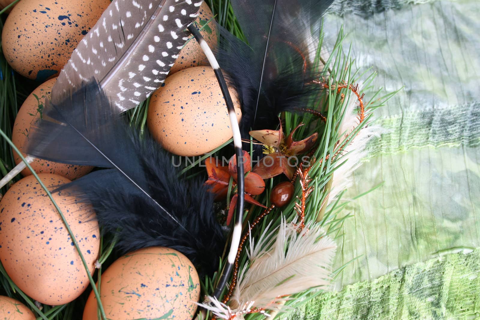 Decorated eggs in a wreath on a green background