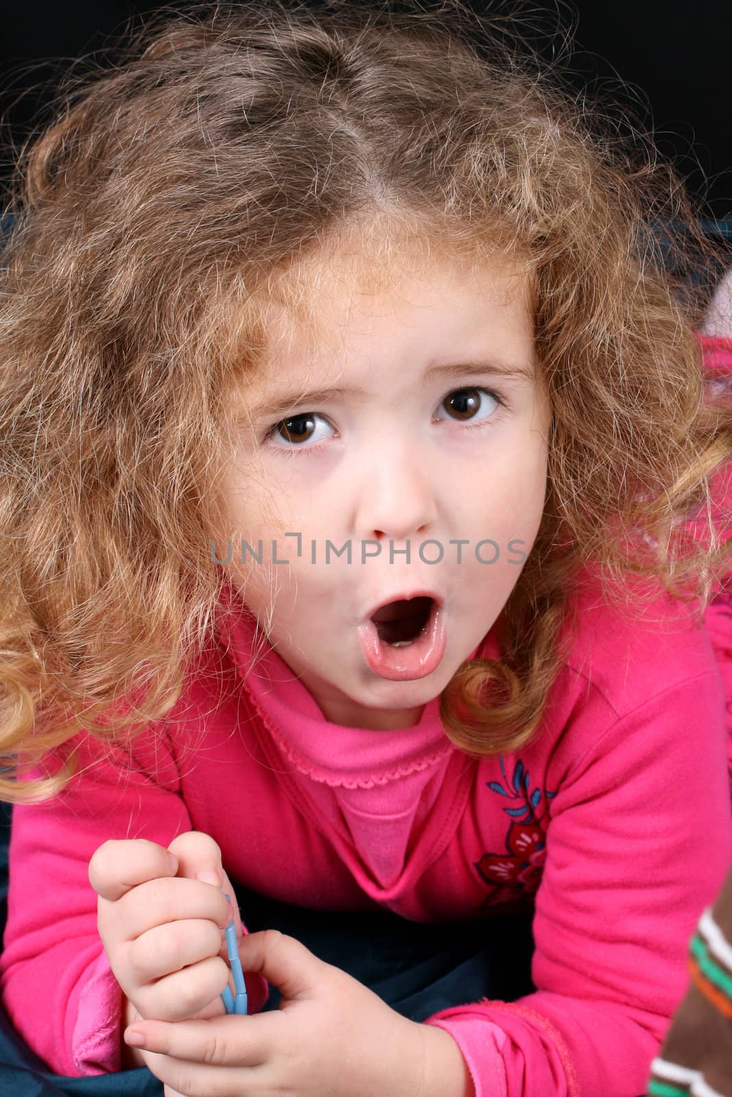 Beautiful young girl with curly hair and cute features
