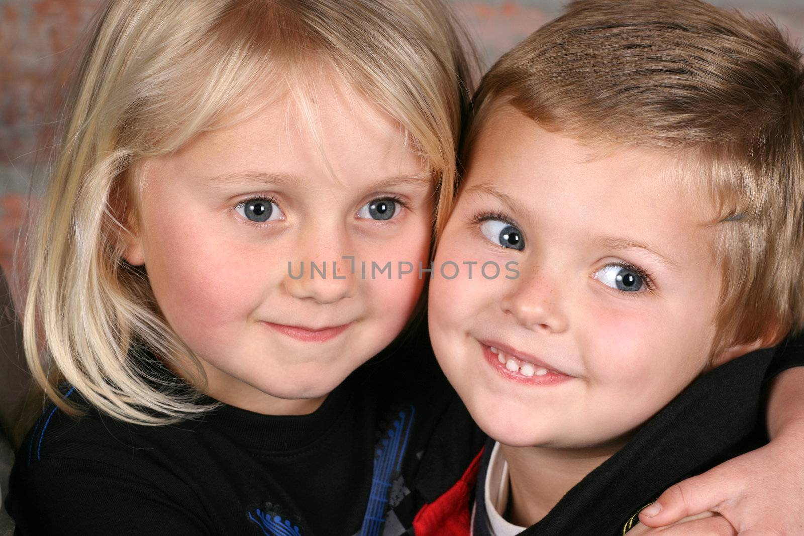 Beautiful young girl with blond hair and her cute boy friend
