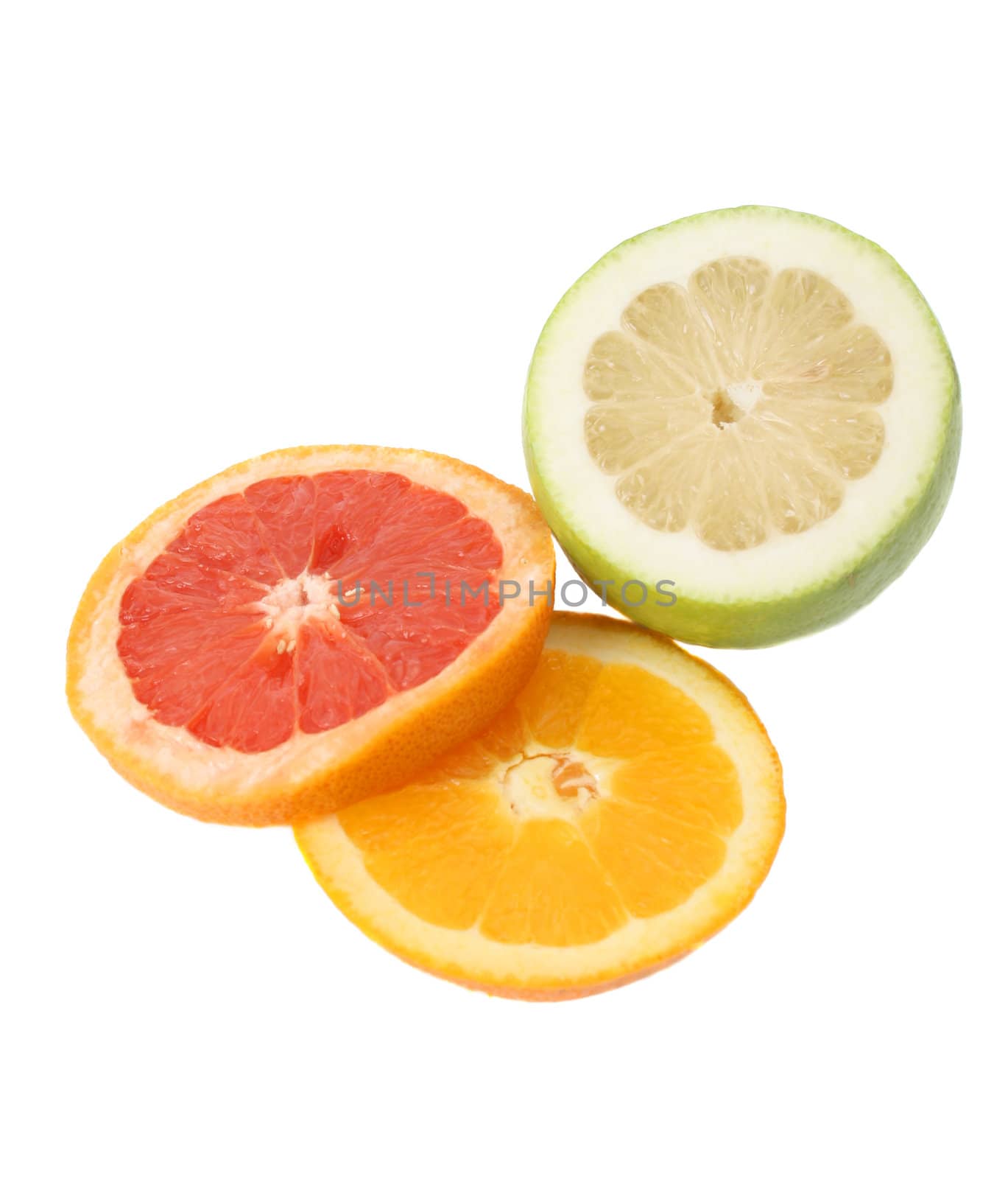 Freshly sliced pomelo, lime and orange on a white background