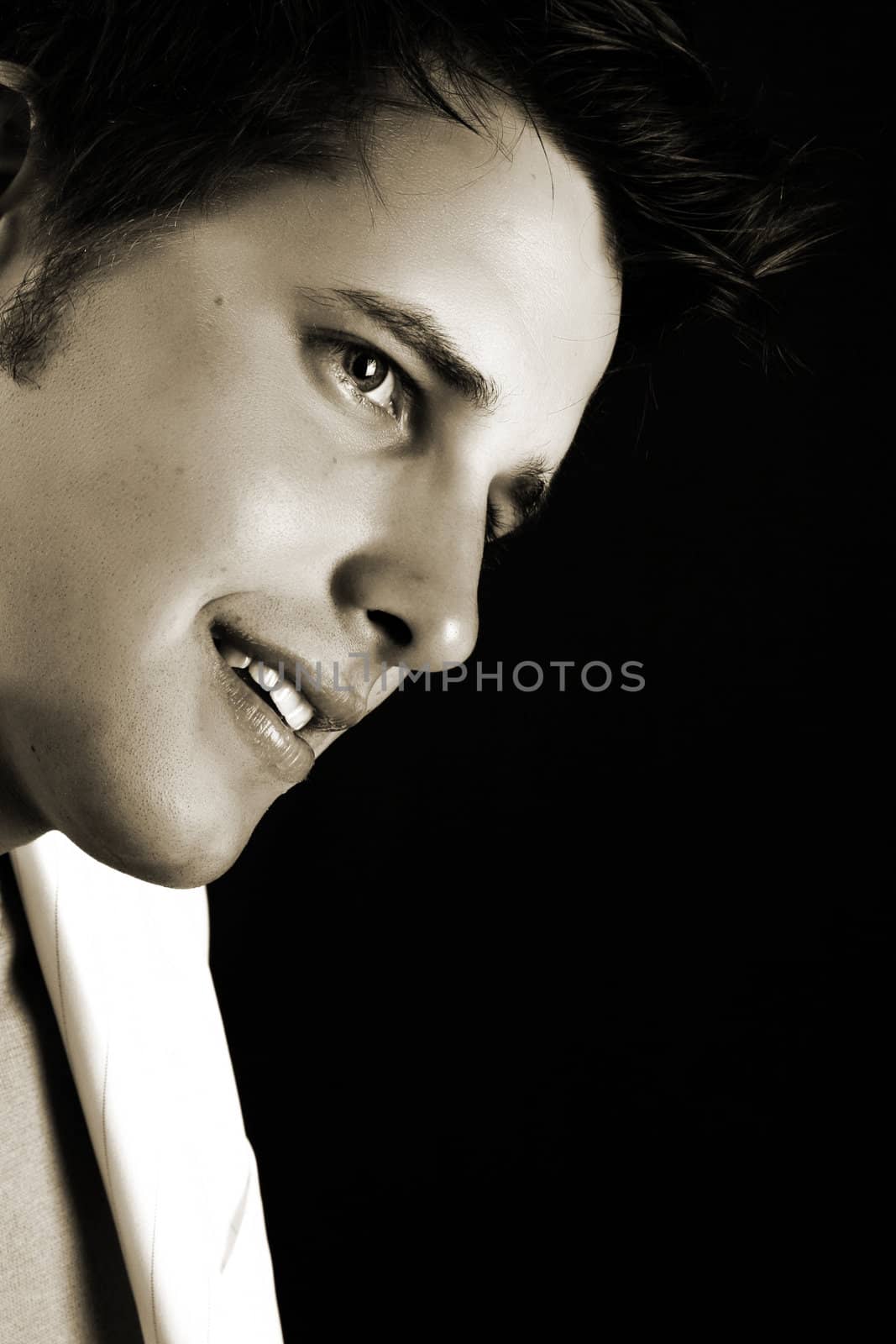 Male model in studio against black background 