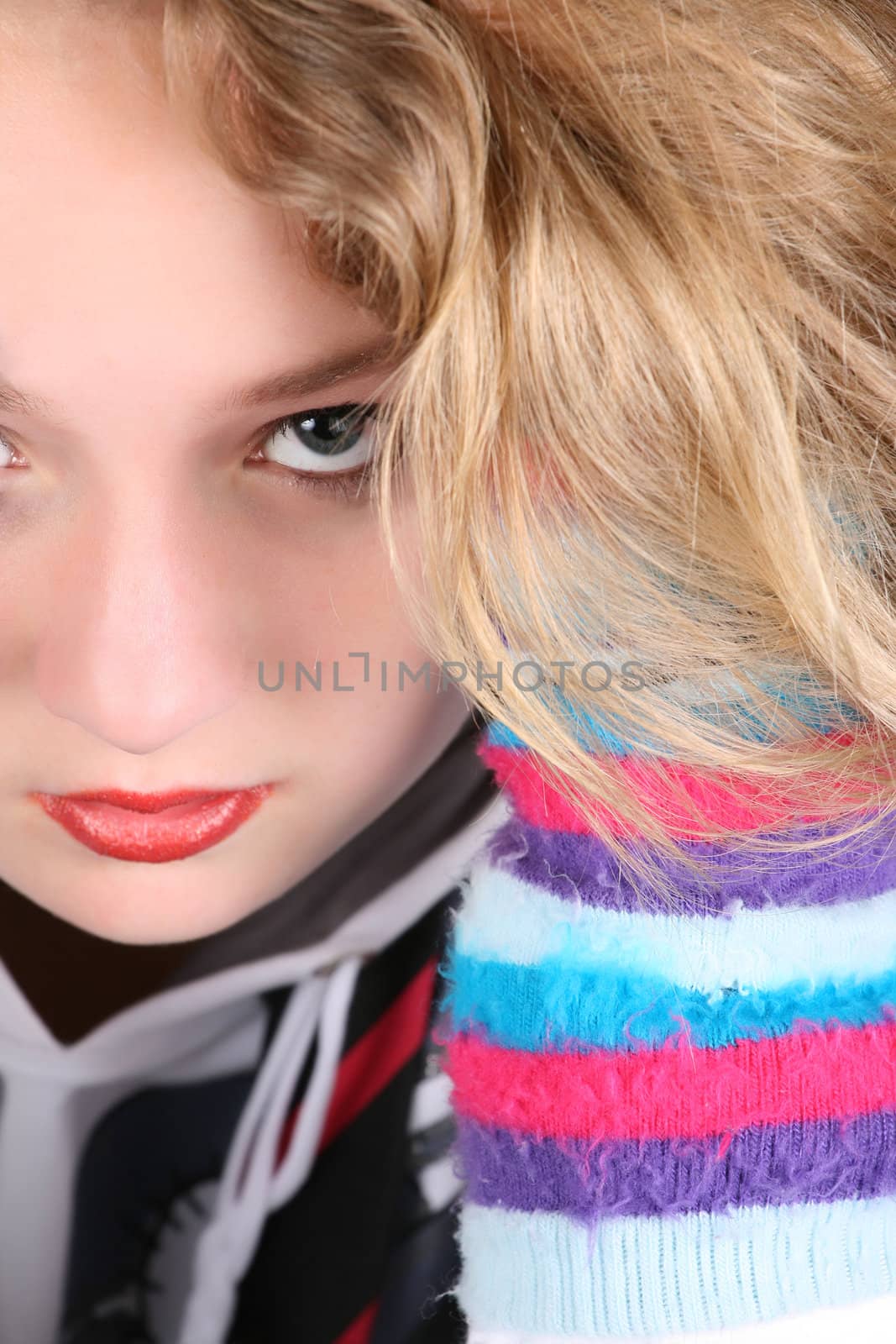 Serious caucasian teen with curly hair wearing colorful gloves