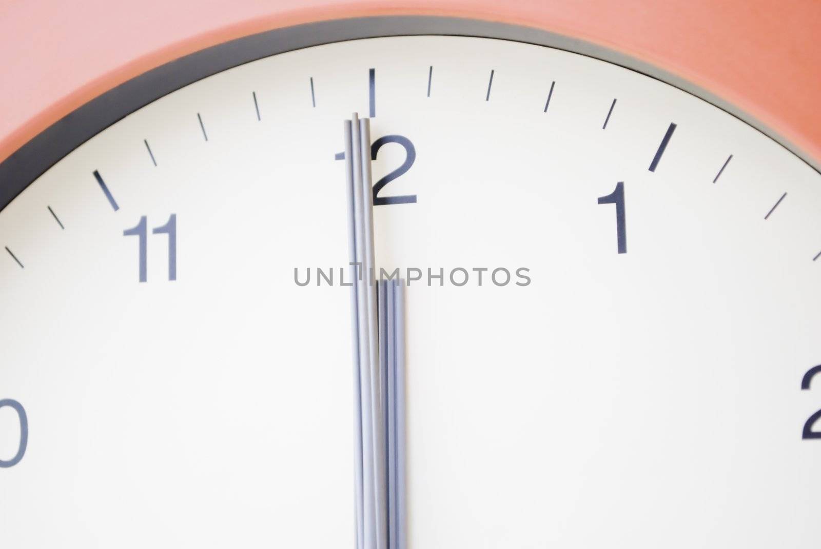 Clock with hands at 12am, midnight.  No visible background.  Cream face with black markings and sans serif typeface.  Grey hands.  Terracotta frame.