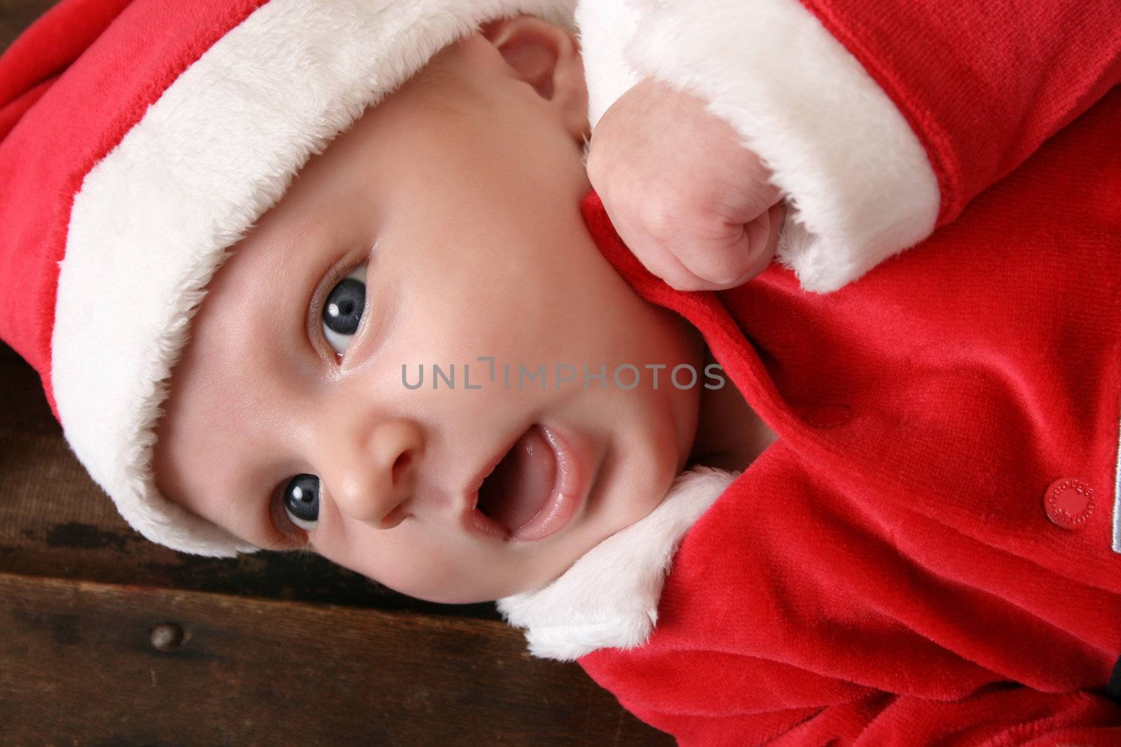 Cute 6 week old baby boy wearing a christmas suit