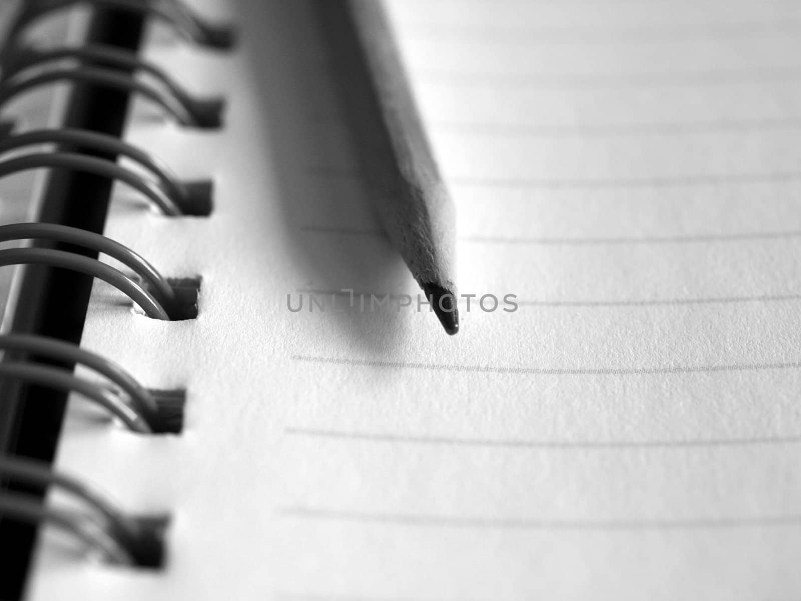 Blank notebook page with pencil on top
