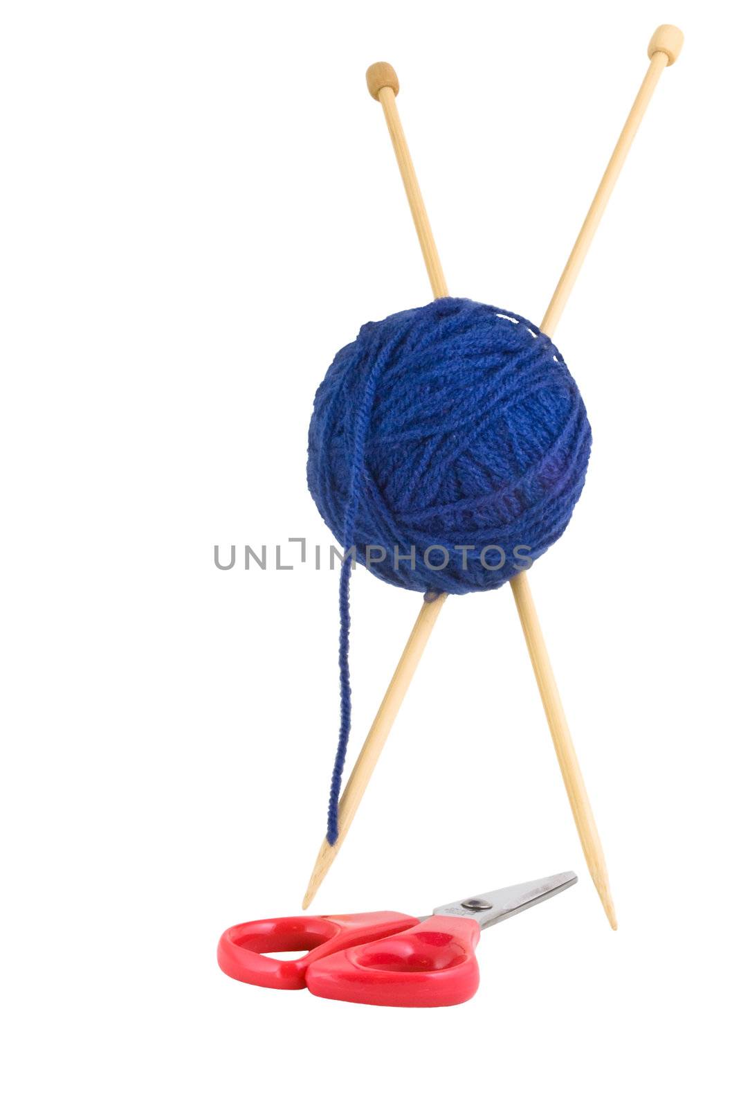 Wooden knitting needles standing upright in an X shape, pierced through a blue ball of wool, straddling a pair of red handled scissors.