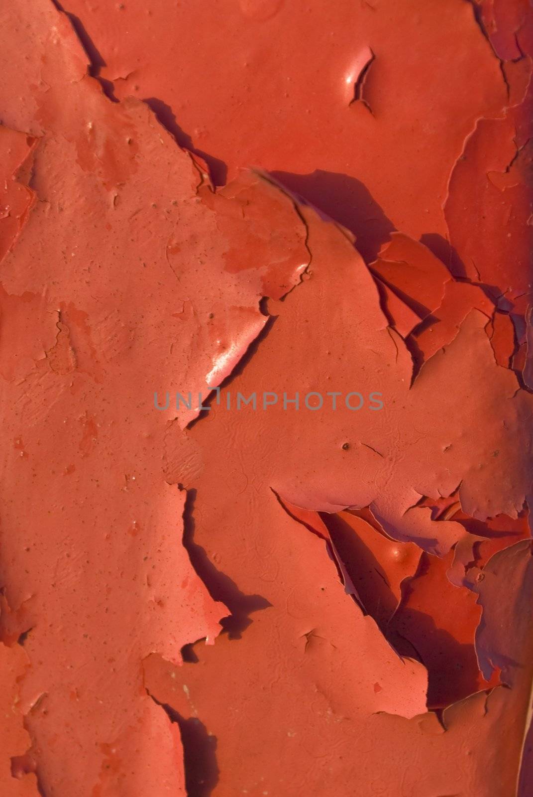 Close up of peeling red paint on an iron structure