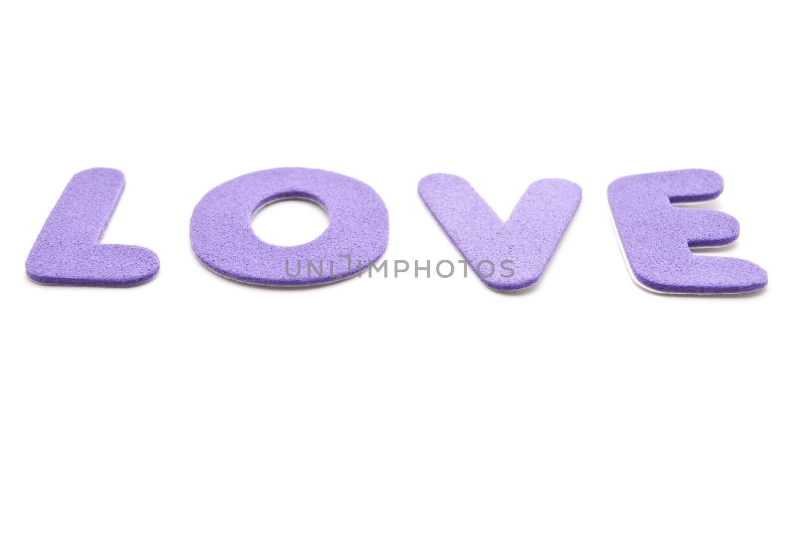 The word 'Love' spelled out in mauve lettering  on a white background.